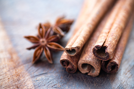 Cinnamon sticks and anise stars on wooden table, herb and spice, food ingredientの写真素材