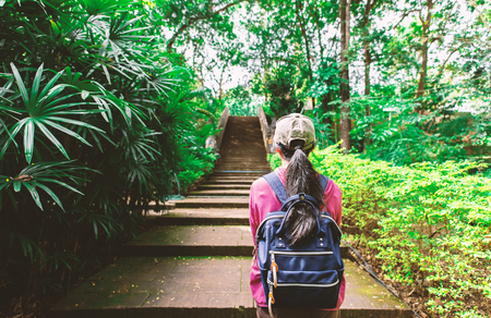 Traveler woman standing at old stairway in Wat Umong temple, Chiangmai, Thailandの写真素材