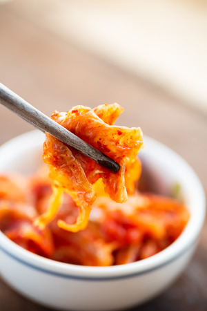 Kimchi cabbage in a bowl with chopsticks for eating, Korean foodの写真素材