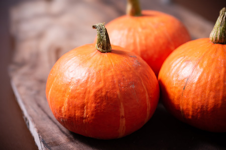 Orange pumpkins on wooden backgroundの写真素材