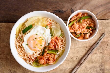 Kimchi noodle spicy soup with egg and vegetables, Korean foodの写真素材