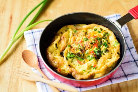 Omelette with spring onion in a panの写真素材