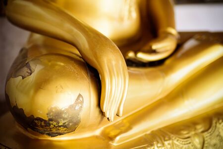Close up hand of Golden buddha statue in the templeの写真素材