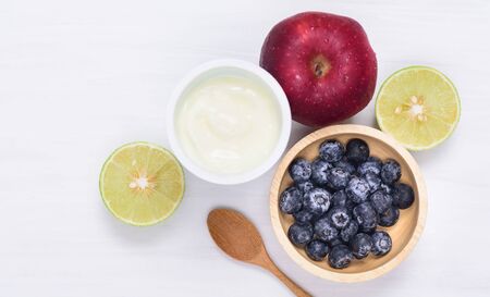 Yoghurt eating with blueberry, apple and lime on white background, healthy foodの写真素材