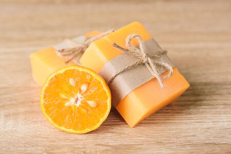 Orange soap wrapping with paper and ribbon, homemade soapの写真素材