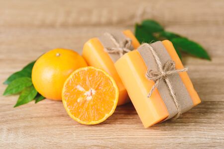 Orange soap wrapping with paper and ribbon, homemade soapの写真素材