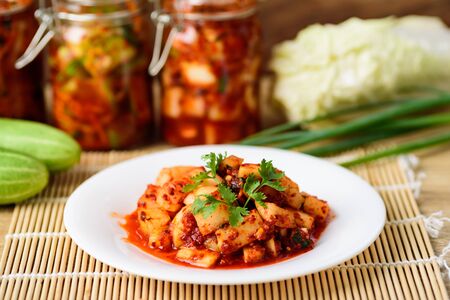 Kimchi radish on white plate, homemade Korean foodの写真素材