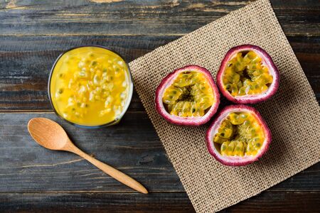 Glass of passion fruit juice and fresh passion fruit on wooden background,tropical fruitの写真素材