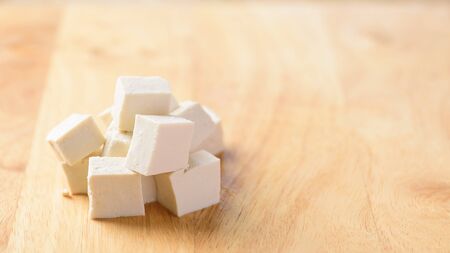Sliced tofu for cooking on wooden background with copy spaceの写真素材