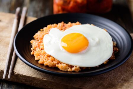 Kimchi fried rice with fried egg on top and chopsticks for eating, Korean foodの写真素材