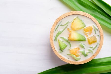 Thai dessert (Lod Chong), rice flour pandan flavor and sliced melon fruit in coconut milkの写真素材