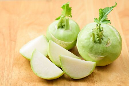 Sliced kohlrabi on wooden background, organic vegetableの写真素材