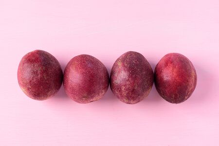 Fresh passion fruit on pink background, tropical fruitの写真素材