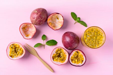 Fresh passion fruit and juice on pink backgroundの写真素材