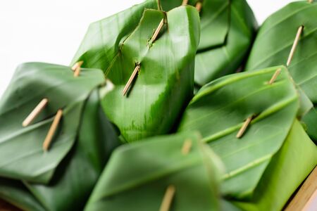 Thai dessert (Khao Niao Sangkhaya), Sweet sticky rice with egg custard wrapping with fresh banana leafの写真素材