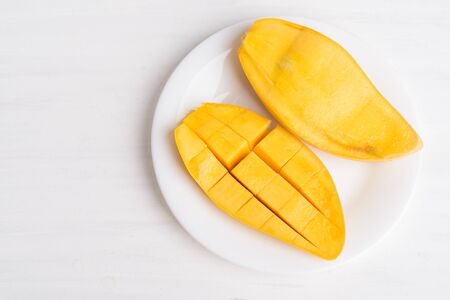 Ripe mango fruit sliced to cubes on white plate ready to eating, Tropical fruit, Thai mango (Nam Dok Mai), Top viewの写真素材