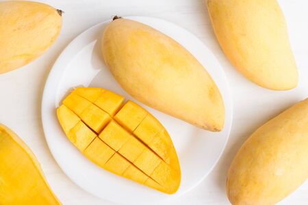 Ripe mango fruit sliced to cubes on white plate ready to eating, Tropical fruit, Thai mango (Nam Dok...