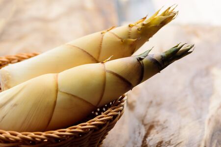 Raw bamboo shoot in a basket on wooden background, Organic Asian foodの写真素材