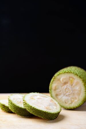 Sliced young jackfruit on black background, food ingredients for Northern Thai food cooking