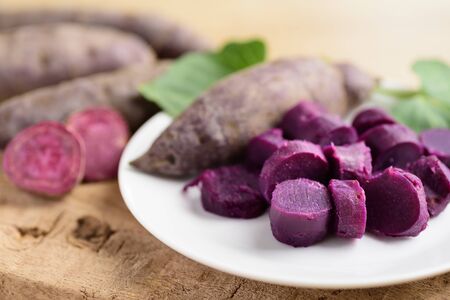 Sliced purple sweet potatoes on plate ready to eatingの写真素材