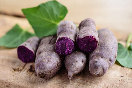 Boiled purple sweet potatoes ready to eating on wooden table, Healthy vegetableの写真素材