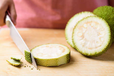 Asian food cooking, young jackfruit chopping on wooden cutting board