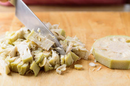 Asian food cooking, young jackfruit chopping on wooden cutting board