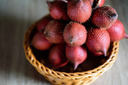 Red salacca fruit in basket, palm fruit native in Southeast Asia