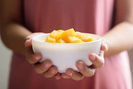 Thai sweet food, pumpkin in sweet coconut milk holding by hand