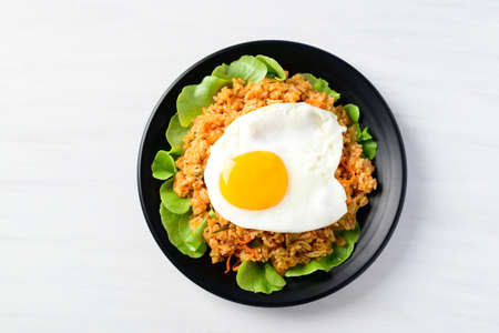 Kimchi fried rice with fried egg on top on white background, Korean food, Top viewの写真素材