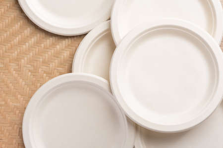 Biodegradable plate, Compostable plate or Eco friendly disposable plate on woven bamboo background,...