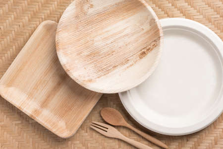 Betel palm leaf plate (Biodegradable, Compostable or Eco friendly disposable plate) on woven bamboo sheet, sustainable conceptの写真素材