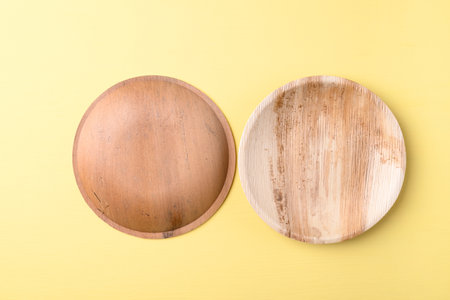 Back and front betal palm leaf plate (Biodegradable, Compostable, Disposable or Eco friendly plate) on yellow background, Sustainable conceptの写真素材