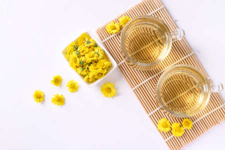 Organic Chrysanthemum flower tea in a cup on white background, Healthy Herbal drink, Top viewの写真素材