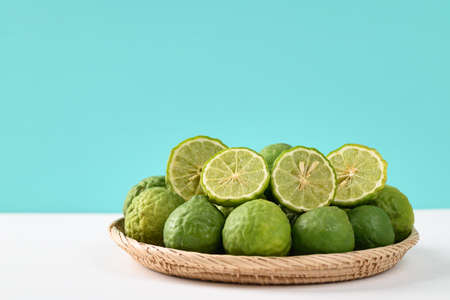 Fresh bergamot fruit in a basket on color background, Food ingredients and extract used for medicine, tea, perfumes and cosmeticsの写真素材