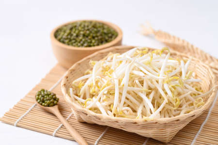 Fresh mung bean sprouts in bamboo basket and mung bean seeds, Organic vegetables and food ingredients in Asian foodの写真素材