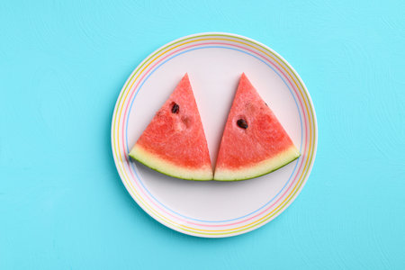 Sliced watermelon fruit on plate with color background, Tropical fruit, Summer seasonの写真素材