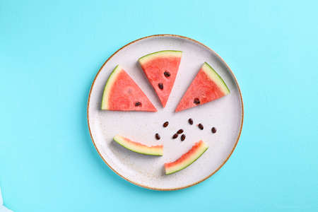 Sliced watermelon fruits with bite and seeds on plate, Tropical fruit, Summer season