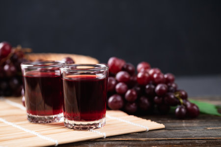Red grape juice in a glass with fresh grape on wooden background, Healthy drink, Still Life