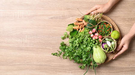 Fresh organic Southeast Asian vegetables and spices from local farmer market, Northern of Thailand, Sustainability concept, Table top viewの写真素材