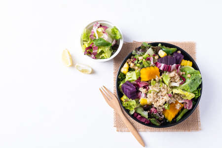 Fresh organic vegetables salad with quinoa seed in bowl on white background, Healthy Vegan food, Top viewの写真素材