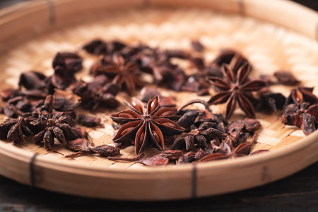 Close up of star anise in bamboo basket on wooden background