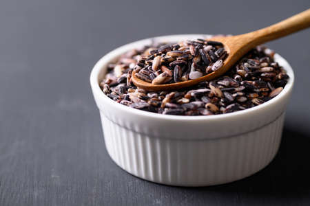 Thai purple glutinous rice grain in bowl with spoon, Organic and healthy foodの写真素材