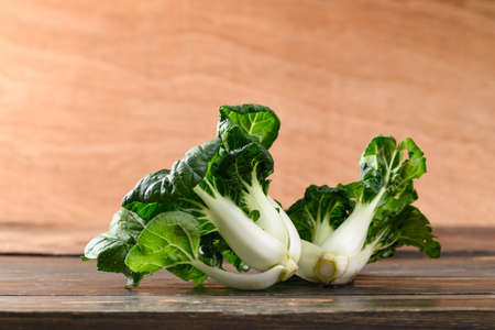 Fresh organic white Bok Choy or Pak Choi (Chinese cabbage) on wooden background