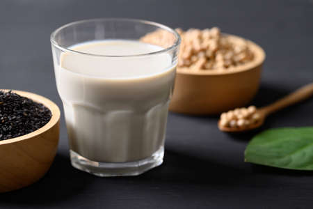 Soy milk with black sesame on black background, Healthy drinkの写真素材