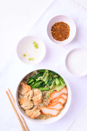 Noodles soup with wonton dumpling and grilled red pork, Asian food, Top viewの写真素材