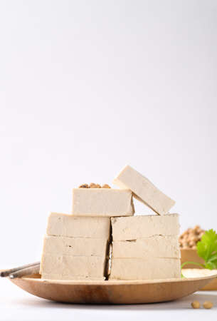 Organic tofu on biodegradable plate with white background, Vegan food ingredients in Asian cuisine, plant basedの写真素材