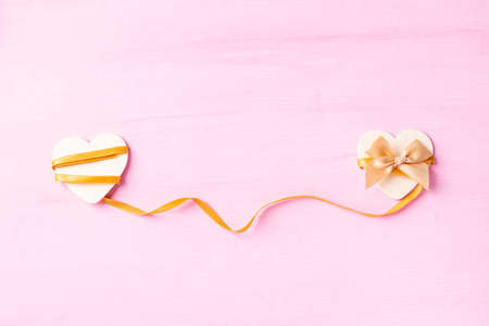 Two heart shape with ribbon on pink background, Valentine day conceptの写真素材