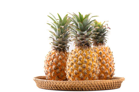 Fresh pineapple fruit in basket on white background, Tropical fruitの写真素材