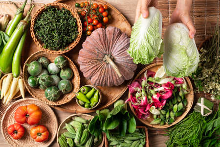 Fresh organic Southeast Asian vegetables and edible flowers from local farmer market, Northern of Thailand, Sustainability conceptの写真素材